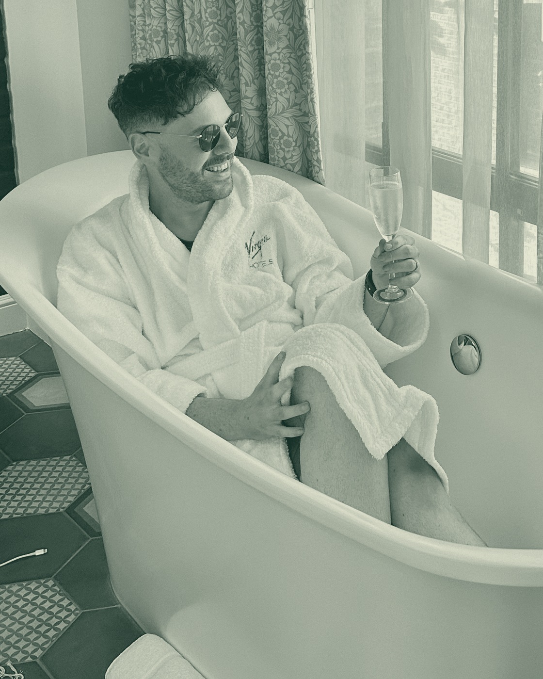 David Todd smiling in a Virgin Hotels bathtub